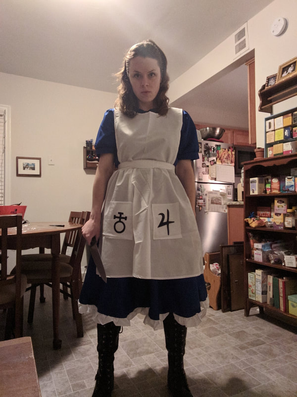 A full body shot of Maddie, in her Alice Madness Returns cosplay, looking intensely at the camera.