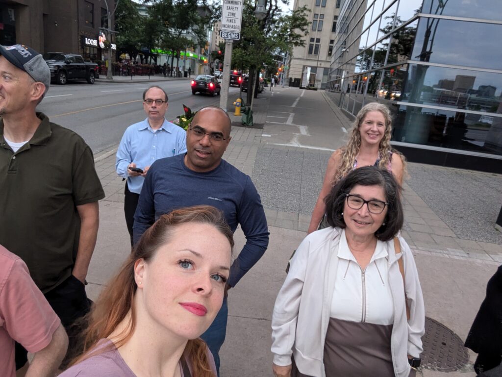 A photo with Maddie and several members of The Wandering Francophones, a Michigan-based French language meetup, walking along the street in downtown Windsor.