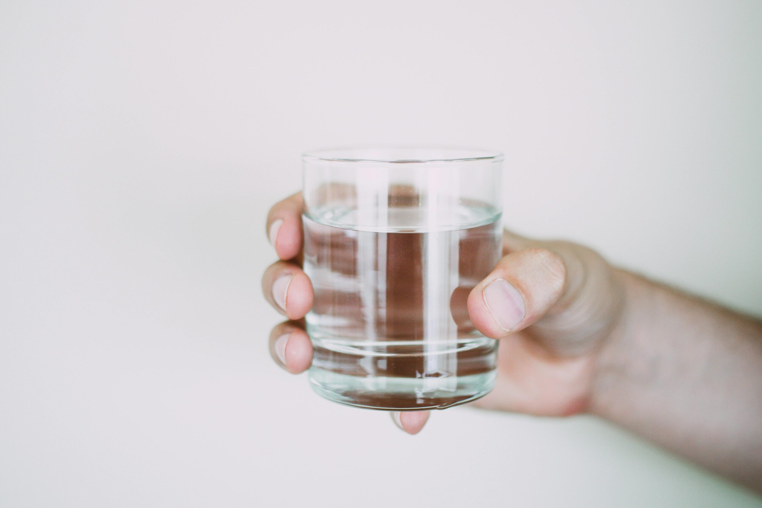 A person holding a glass of water.