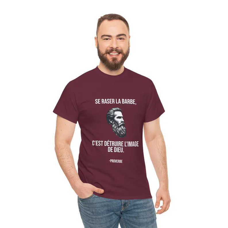 A product photo of a male model with a beard wearing a maroon colored t-shirt that says "se raser la barbe, c'est détruire l'image de Dieu".