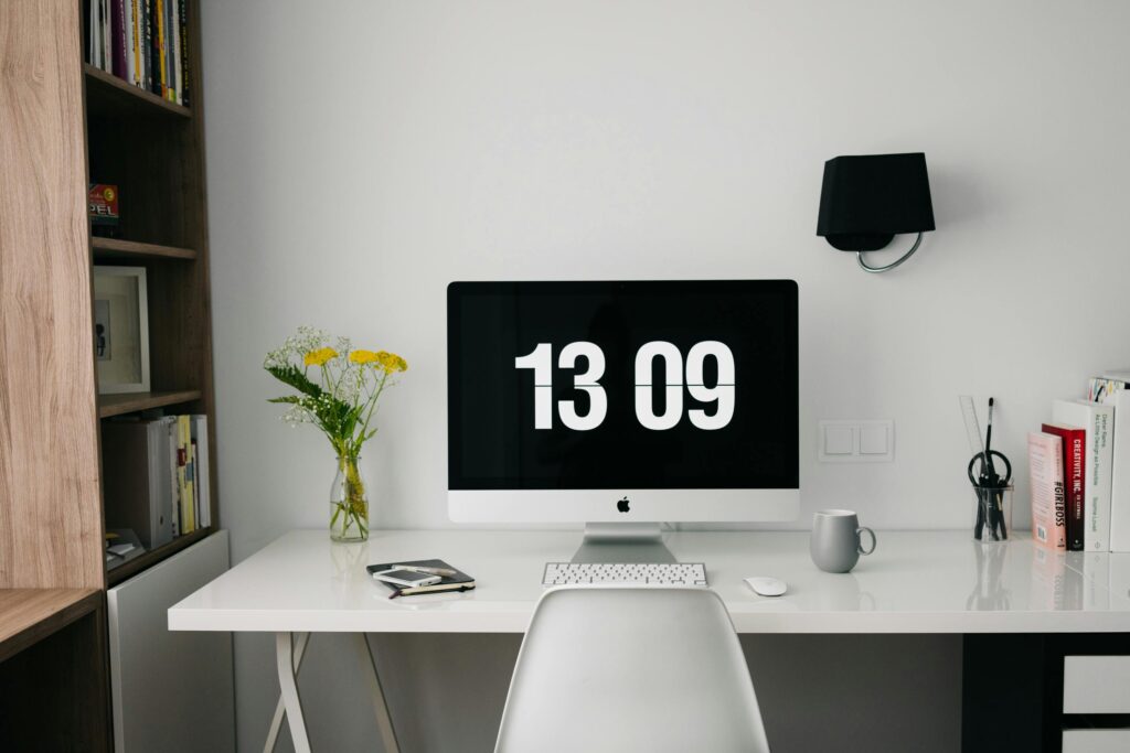 A photo of a computer monitor with a large digital clock shown on the monitor.