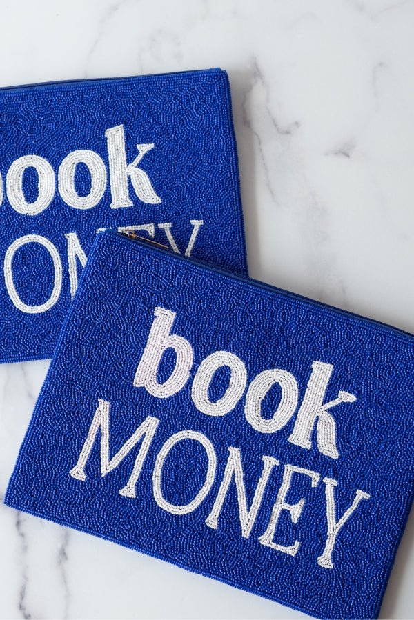 An image of two hand beaded blue and white clutch purses that say 'book money' on the front.